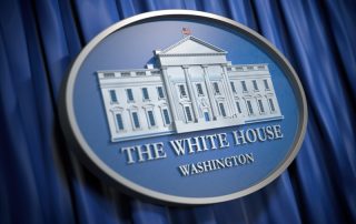 white house sign in front of curtain