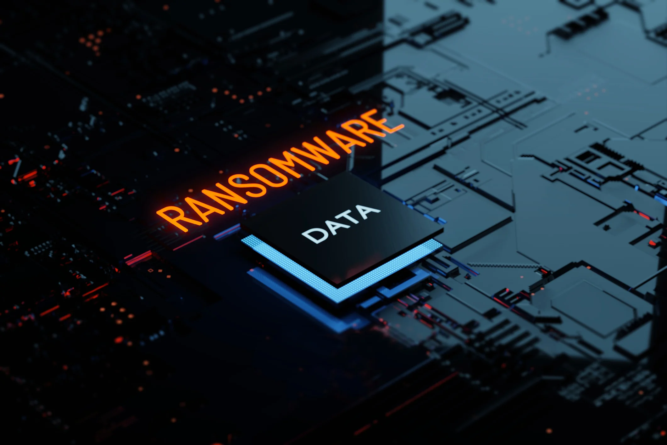 This image features a digitally rendered scene of a circuit board, focusing on themes of cybersecurity and digital threats. The word "RANSOMWARE" glows in a striking red hue across the center, indicating the theme of the image. Adjacent to it, "DATA" is illuminated in blue, emphasizing the target of such cyber threats. The background shows a high-tech circuit board design in blue and black tones, with intricate patterns and electronic components. The overall mood of the image is dark and foreboding, underlining the danger and seriousness of cyberattacks like ransomware.