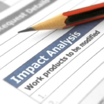 Canva image. The image shows a close-up of a document labeled "Impact Analysis" with the phrase "Work products to be modified" underneath. A sharpened pencil is positioned diagonally on the document, emphasizing the text. The image suggests an analysis or evaluation process, with the pencil symbolizing planning or marking important points. The context appears to involve reviewing or modifying work processes or products based on the impact analysis findings.