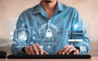 Mitigating DoppelPaymer ransomware effects. The image depicts a person typing on a keyboard, with a digital overlay of cybersecurity elements. There is a semi-transparent shield icon with a padlock in the center, symbolizing security, and other icons related to data protection and technology around it. On the right side, there’s a digital login form interface, showing fields for a username and password. The overall theme of the image appears to be related to cybersecurity and secure online access. The person in the image is wearing a blue shirt, though their face is not visible.