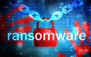 Post-attack cybersecurity improvements. The image shows the word "ransomware" prominently displayed in large white or light-colored text against a dark background. Behind the text is a red padlock symbol, representing security or access restriction, with a broken chain extending from each side, symbolizing a breach or vulnerability. The background features binary code (sequences of 1s and 0s), giving the image a digital or cyber feel. The design emphasizes the concept of ransomware as a threat that "breaks" or bypasses security, targeting and locking down data in the digital world.