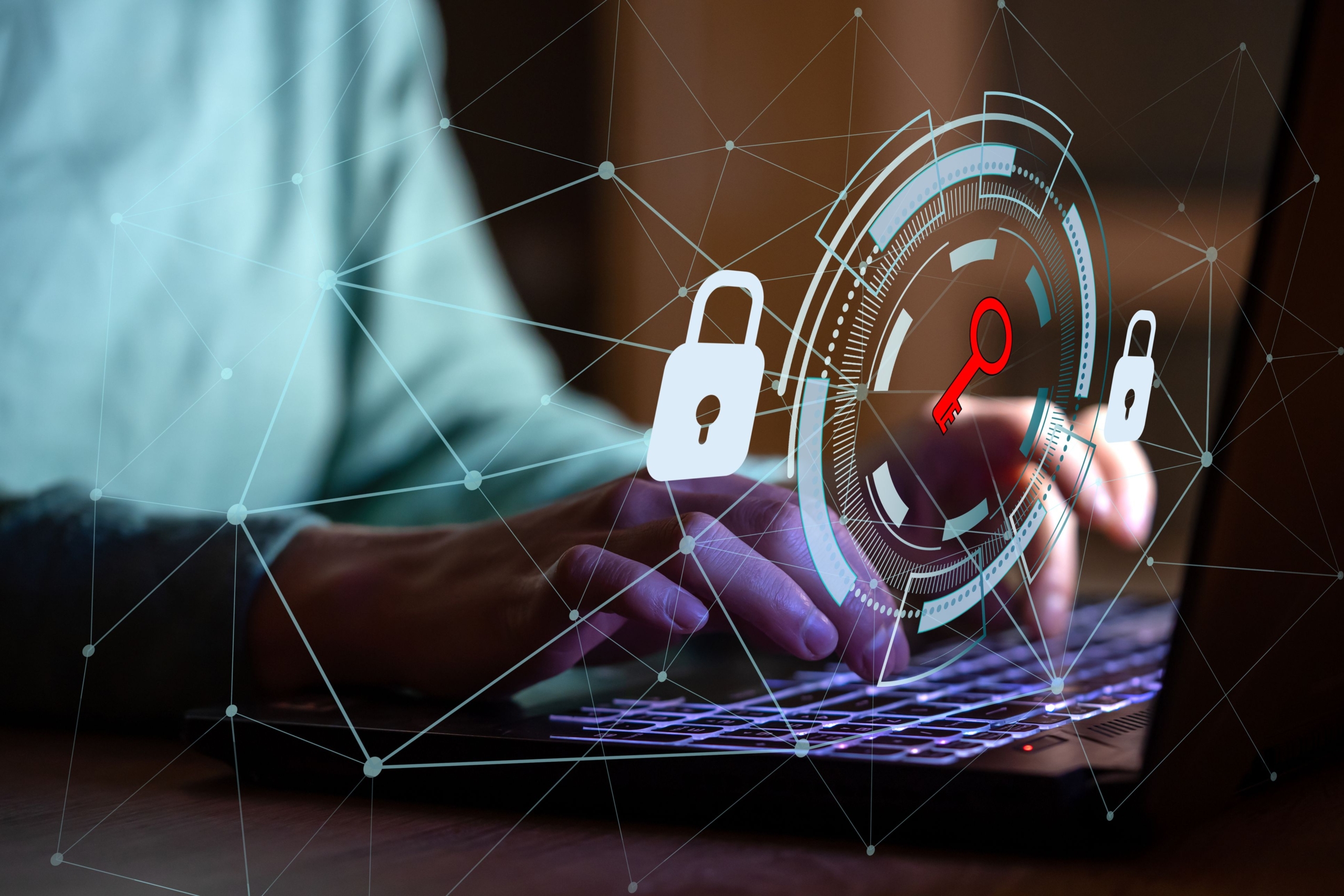 Cybersecurity training to prevent ransomware. The image shows a conceptual representation of cybersecurity, blending human interaction with digital elements. In the foreground, hands are typing on a laptop keyboard, indicating an active engagement with technology. Overlaid on the scene is a futuristic graphic interface featuring a circular target-like design, with a glowing red key symbol at its center. This symbolizes access, security, or unlocking sensitive information. Surrounding the circular graphic are padlock icons, emphasizing data protection and security measures. Additionally, thin white lines and dots form a network pattern across the image, representing interconnected systems or a web of digital connections. The background is softly blurred, focusing attention on the hands and the digital interface, creating a blend of human and technological elements. The image conveys themes of cybersecurity, digital access, and the importance of safeguarding data.