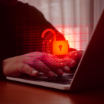 Cyber breach legal support. This image shows a person typing on a laptop keyboard, with a digital overlay of a glowing red lock icon surrounded by circular patterns and binary code. The red lock symbol indicates a cybersecurity or data protection theme. The background is blurred, and the red color scheme suggests themes of hacking, security breaches, or online protection. The person's hands are clearly visible, focused on interacting with the laptop, creating a visual representation of digital security concerns.