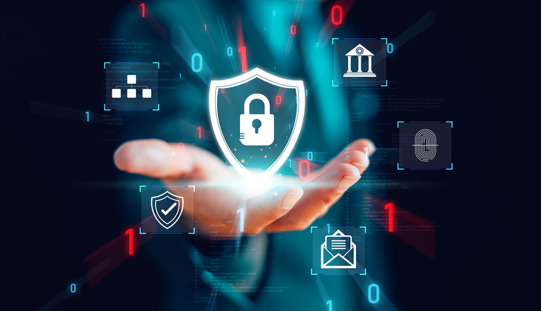 Ransomware recovery timeline. This image features a person’s hand extended with an open palm, as if presenting or holding something. Floating above the hand is a glowing shield icon with a padlock in the center, symbolizing security and protection. Surrounding this central icon are additional holographic-style symbols: a database icon, a government or institutional building, a fingerprint for biometric authentication, a shield for defense, and an envelope representing secure communication. The background is dark, with scattered binary code (1s and 0s) glowing in blue and red, enhancing the futuristic and cyber-centric theme. The overall focus is on cybersecurity, data protection, and digital trust.