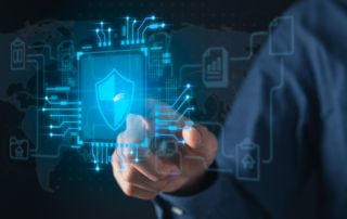 Disaster Recovery as a Service (DRaaS). A close-up of a hand reaching towards a floating digital interface that displays a shield with a checkmark at its center. The background includes a futuristic, circuit-like design with interconnected symbols such as a database, a house, and bar graphs, suggesting data security and protection.