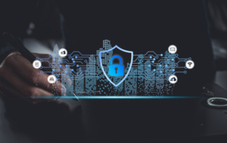 Endpoint protection for ransomware defense. A hand holding a stylus hovers over a digital surface. A glowing blue shield with a padlock appears in front of a futuristic cityscape made of lines and dots, symbolizing digital protection for urban networks.