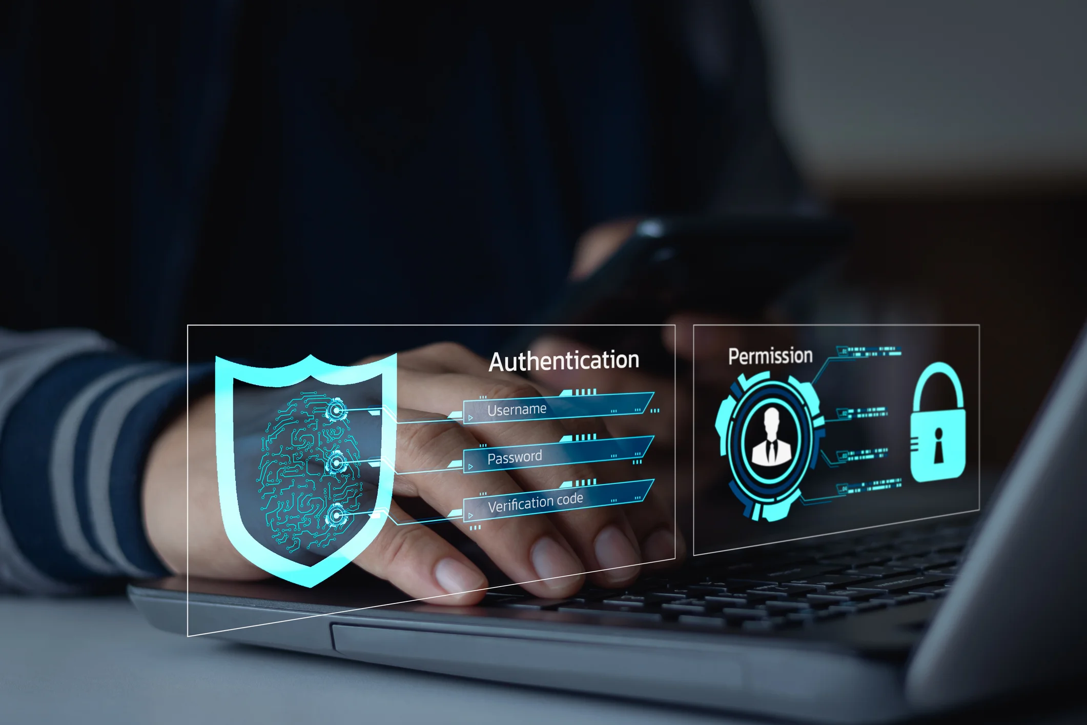 Human error in ransomware attacks. A person is typing on a laptop keyboard, with their hands partially visible. Overlaid on the image is a futuristic digital authentication interface, featuring a glowing blue shield with a fingerprint-like circuit design inside. The interface displays "Authentication" with fields for Username, Password, and Verification Code, emphasizing secure login procedures. To the right, another panel labeled "Permission" shows a user profile icon and a padlock, symbolizing access control and data security. The background is blurred, creating a high-tech, cybersecurity-themed aesthetic focused on identity verification and secure access.