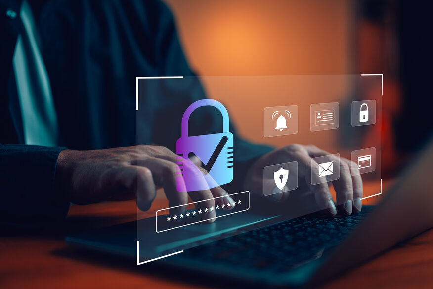 Integrating ransomware threat detection systems. A close-up of hands typing on a keyboard with a digital overlay showing a glowing padlock with a checkmark. Other icons, such as a bell (for notifications), an email, a shield, and a password entry field, appear on the screen, symbolizing cybersecurity and secure login authentication.