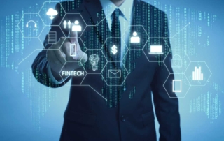 Enterprise Disaster Recovery Planning. A man in a business suit interacts with a transparent screen showing various technology icons. The display includes symbols for fintech, cloud, identity management, money, data analytics, and security—conveying themes of digital finance and secure systems.