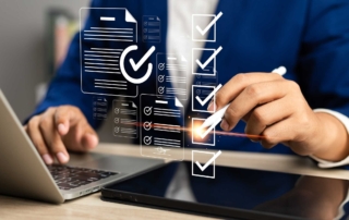 Employee Cyber Hygiene Training. A person in business attire uses a stylus to check off floating digital checkboxes and form icons over a laptop and tablet. It illustrates modern digital workflow, approval systems, or incident reporting.