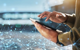 Fast Data Recovery Services. The image features a person using a tablet, with glowing network lines and connection points spreading outward, symbolizing data transmission.