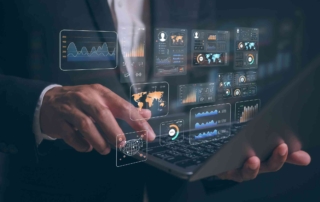 Secure Backup for Business Continuity. A close-up of a person’s hands using a laptop, overlaid with digital data dashboards and global analytics visuals, suggesting business intelligence or data analysis.