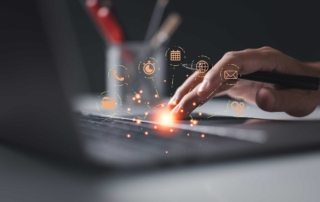 Staff Cybersecurity Best Practices. A hand touches a laptop keyboard, and orange holographic icons (like mail, clock, calendar) float above the keys.
