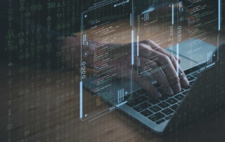 Red teaming ransomware defense. A close-up of hands typing on a laptop keyboard. Overlaid on top are transparent screens filled with lines of computer code, surrounded by faint glowing green numbers and symbols, creating a cybersecurity or hacking theme.